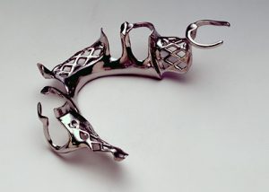 Metal partial denture framework on white background